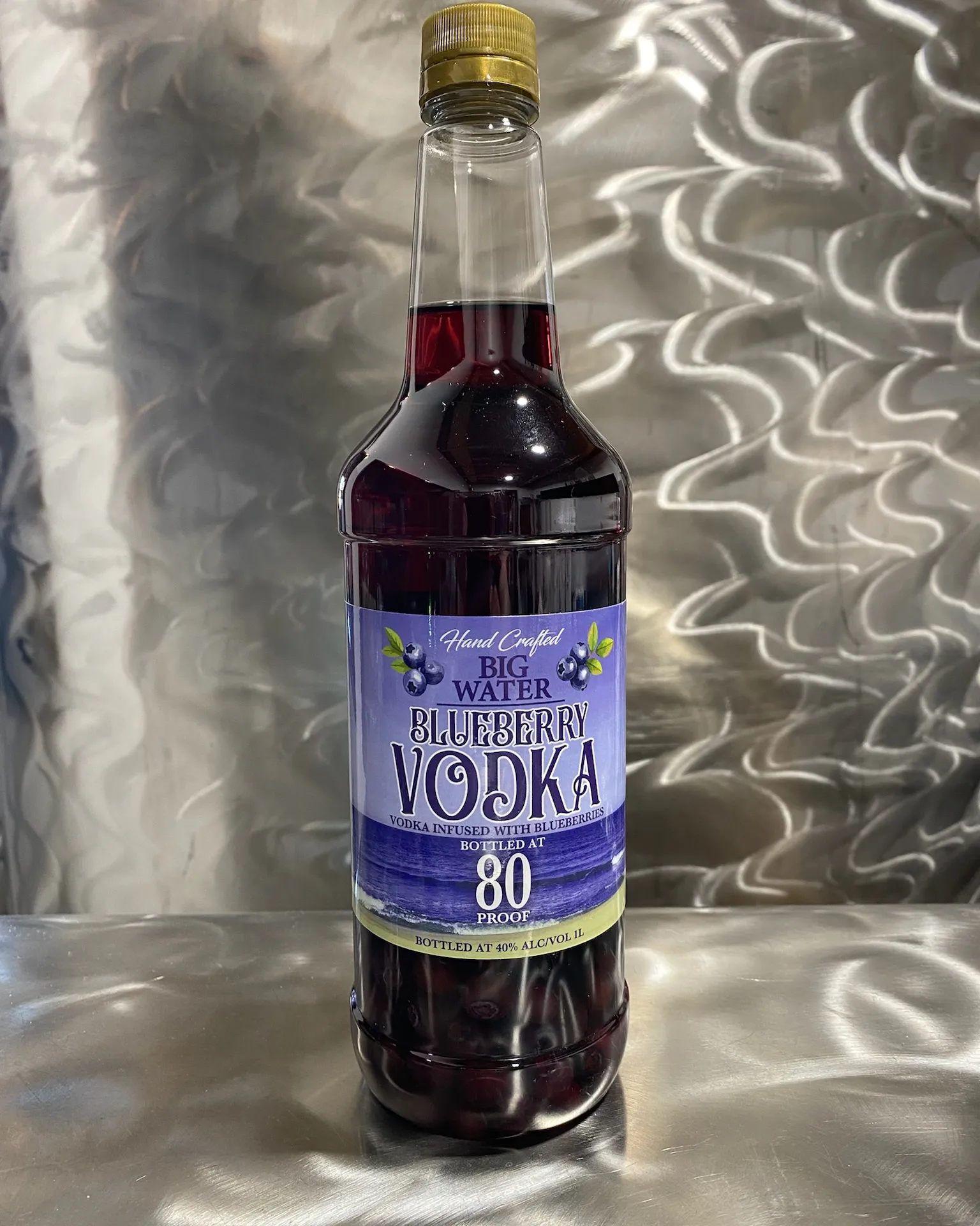 Bottle of Big Water Blueberry Vodka, vodka infused with blueberries, on brushed steel
