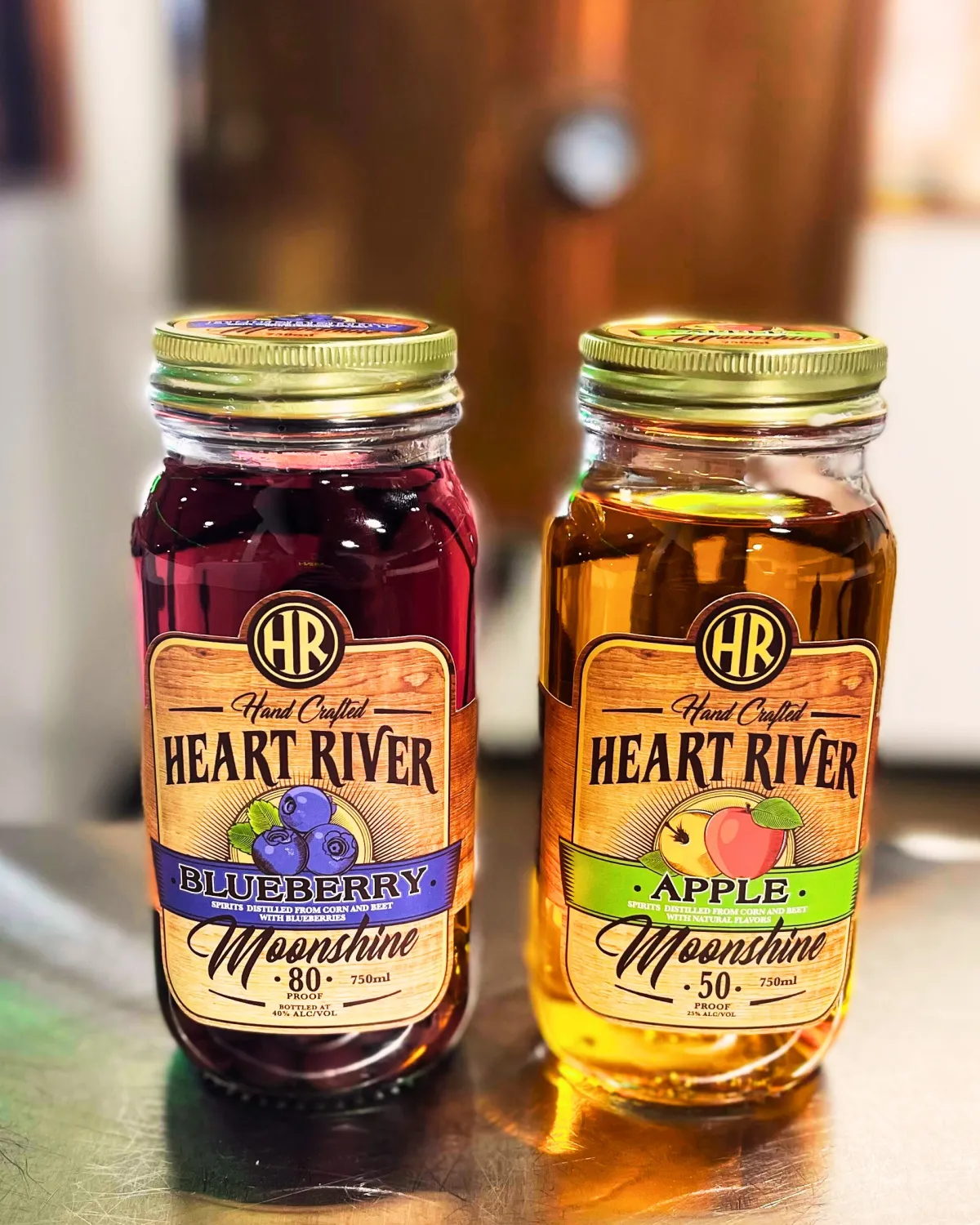 Jars of Heart River Blueberry Moonshine and Apple Moonshine side by side