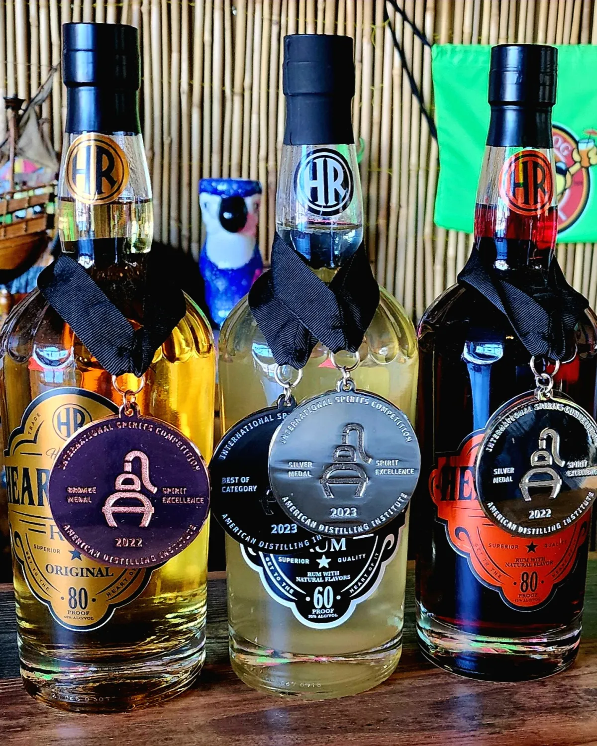 Heart River Original, Coconut and Cinnamon Rum bottles wearing their American Distilling Institute medals