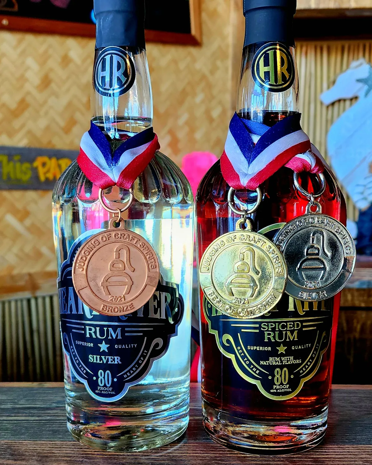 Heart River Silver Rum and Spiced Rum with their ADI medals at the tiki bar