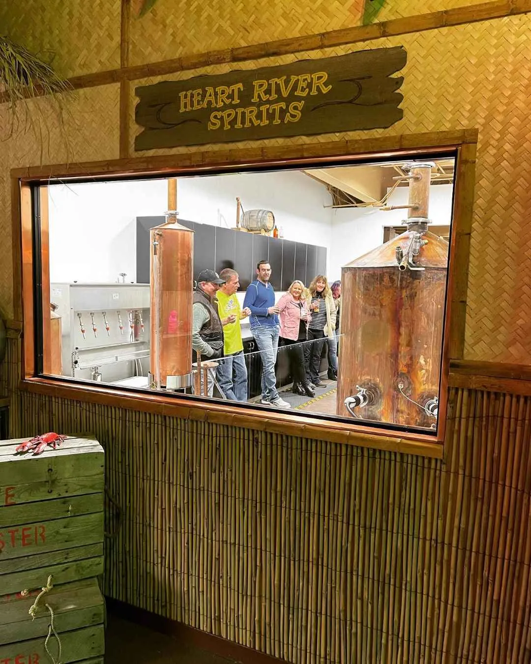 Guests touring the distillery through the window of the Big Dog tiki bar